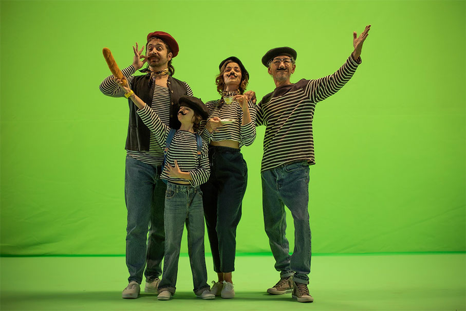 The family dress up for a green screen effect in Croma Kid