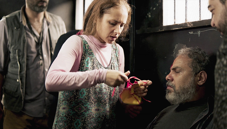 Nagwa attempts to dress the wound of a reluctant Muslim
