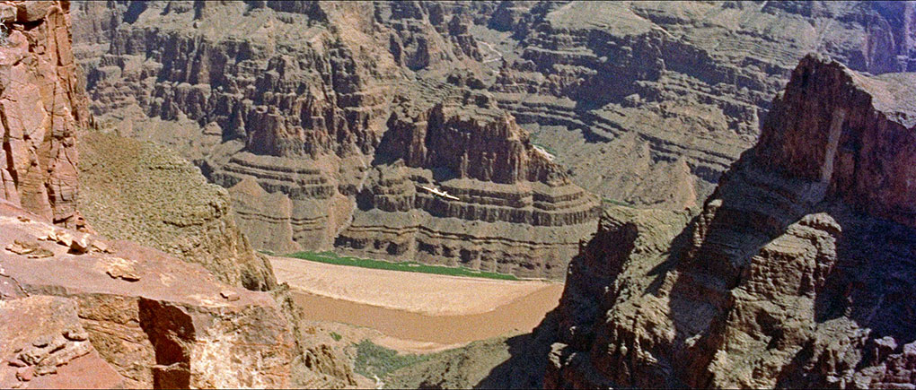 A serch plane flies through the Grand Canyon