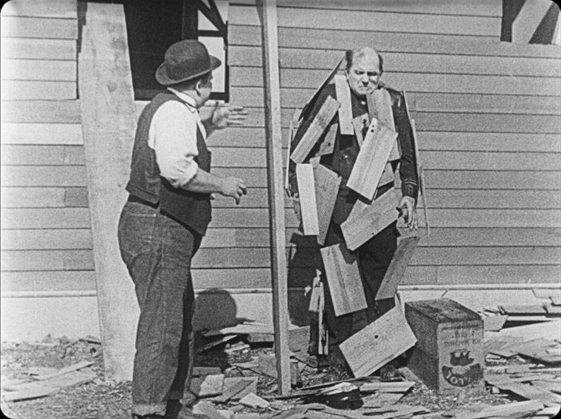 Edgar kennedy's cop gets hit with glue and roof tiles in The Finishiong Touch