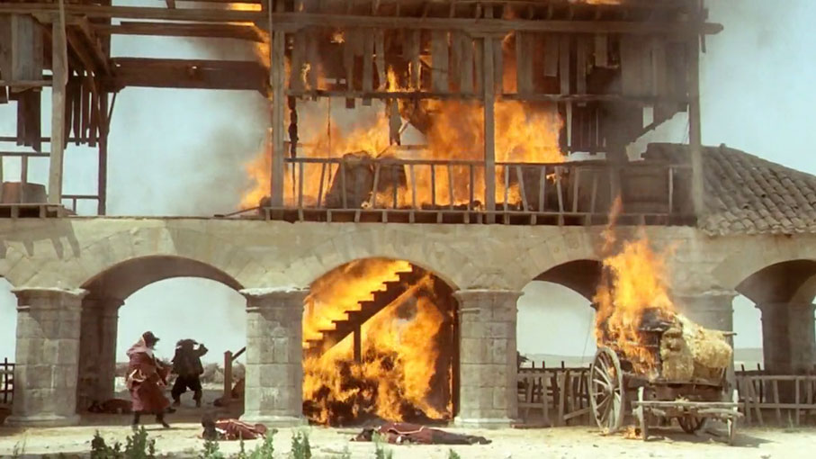 The convent building blazes as the combatants flee