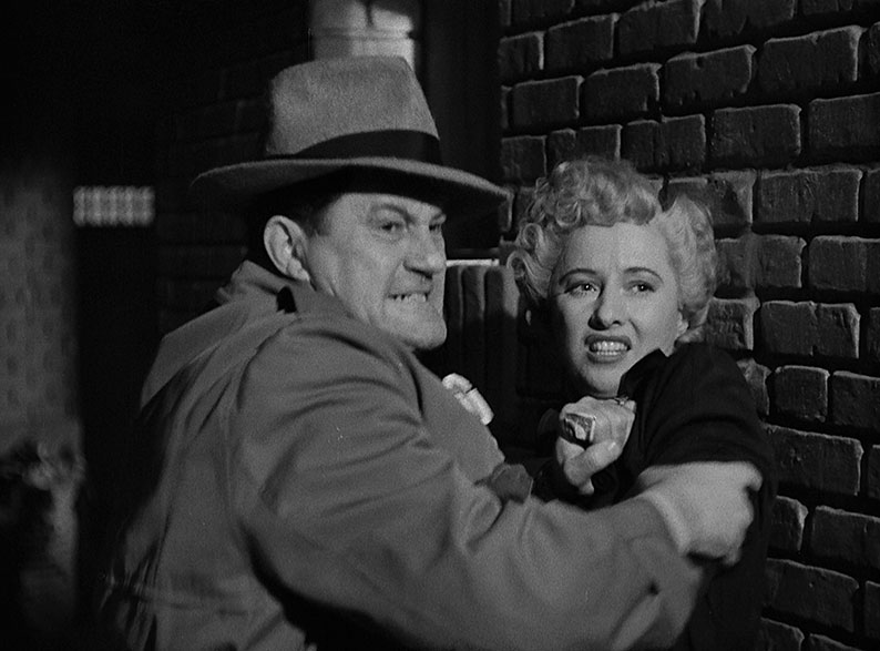 Joan is restrained after she and her partner try to pull a fast on with loaded dice in the opening scene of A Lady Gambles