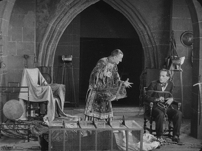 Fu-Manchu tortures Nayland Smith and taunts Dr. Petrie in The Mystery of Dr. Fu Manchu: The Fiery Hand