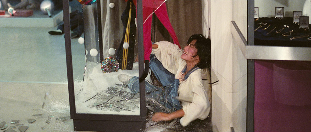 Selina is thrown through a glass cabinet in the climax of Police Story