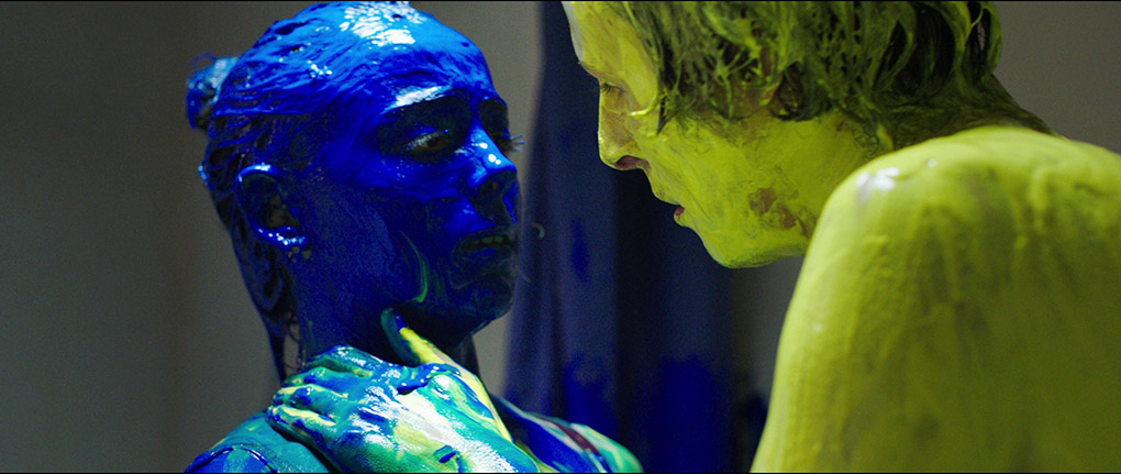 Justine and a fellow student are coated with paint as part of the hazing ritual