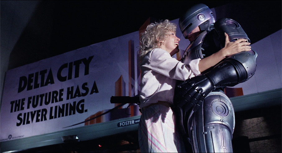 A woman thanks RoboCop after he saves her from attack