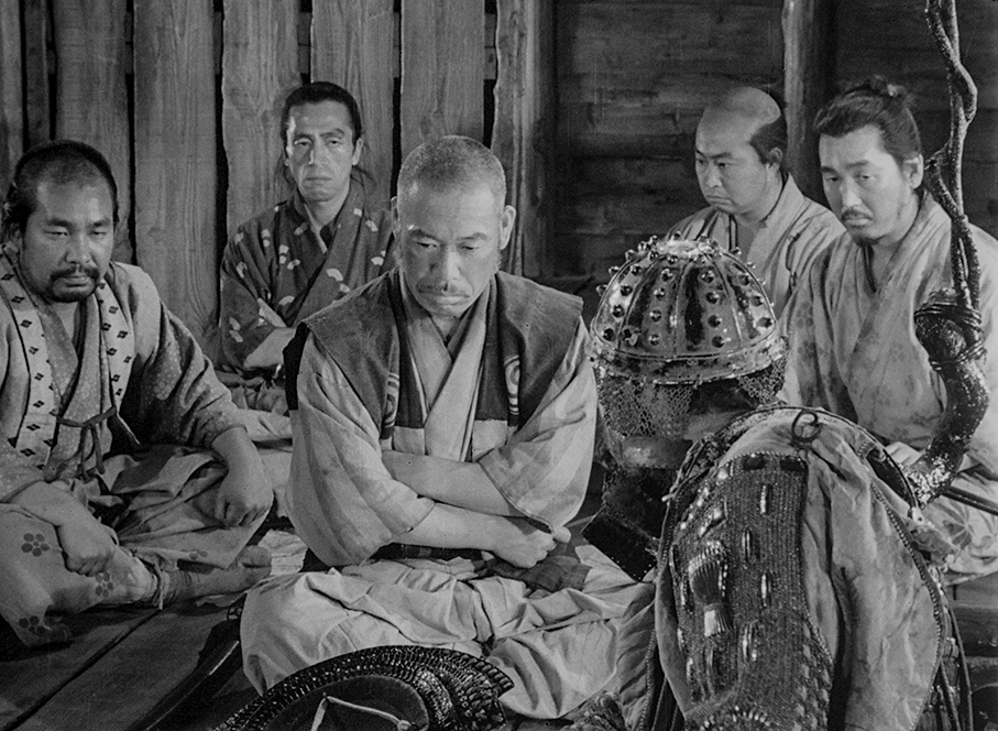 The samurai react to Kikuchiyo's discovery of samurai weapons and armour in a farmer's house