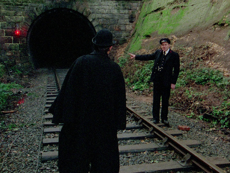The Signalman tells the Traveller about the figure that appeared at the mouth of the tunnel