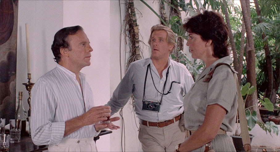 Russell and Claire (Joanna Cassidy) interview Jazy (Jean-Louis Trintignant)