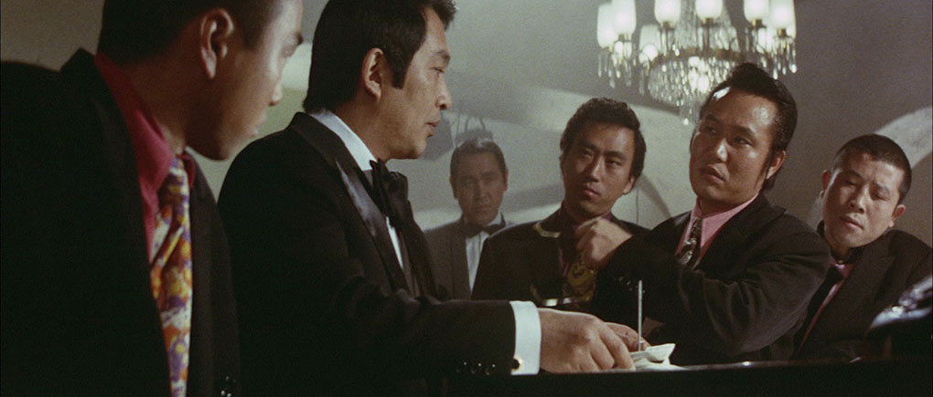Egawa prepares to pay a yakuza for his trouble.